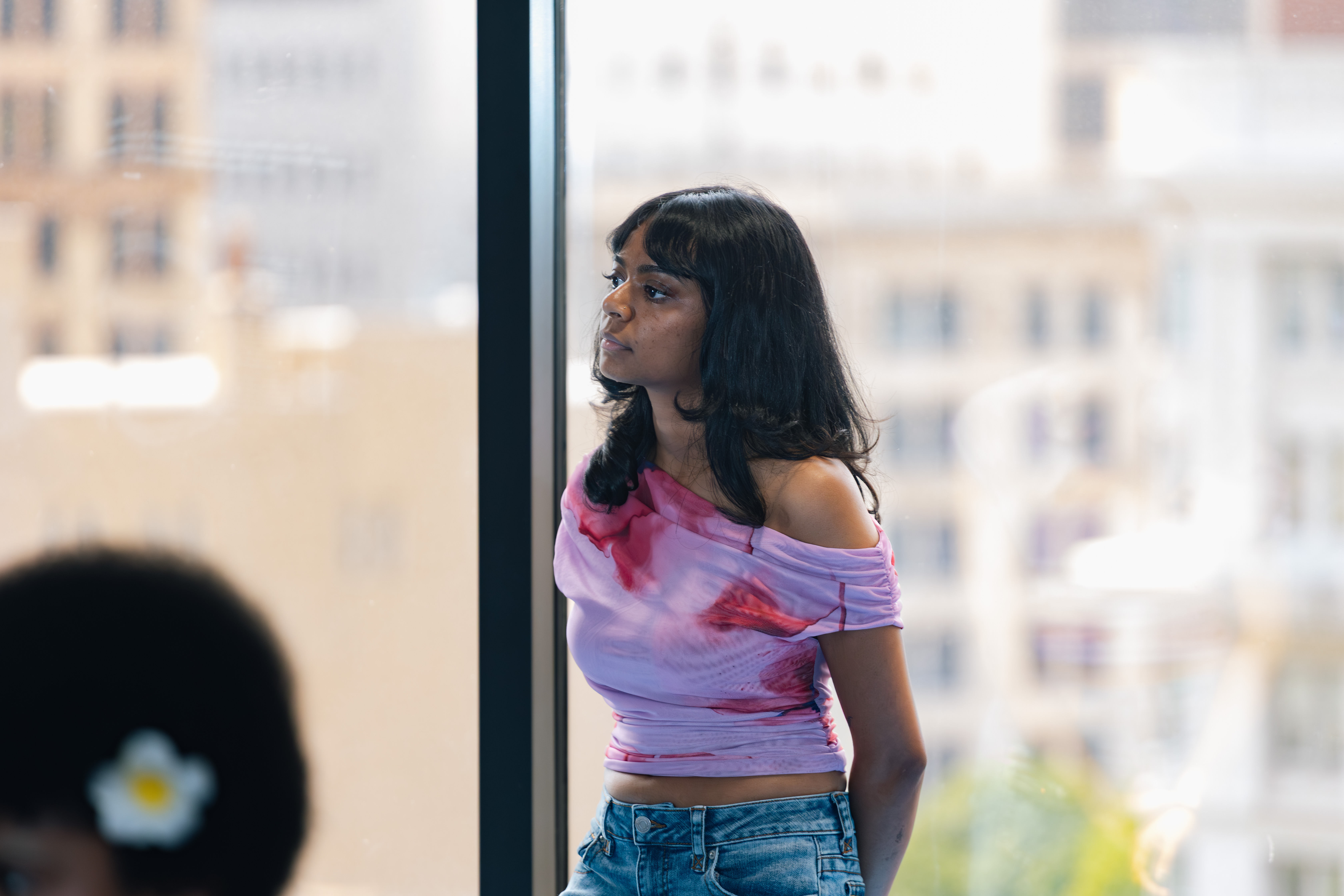 a progirls member looking out over the atlanta skyline